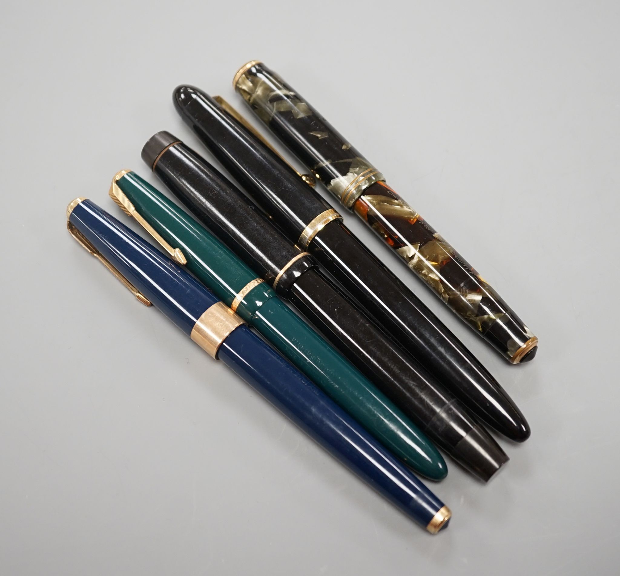 4 fountain pens and a ball point pen